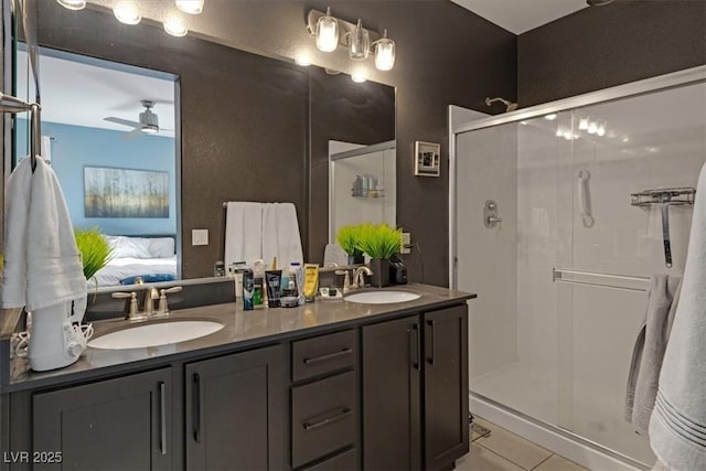 ensuite bathroom featuring a shower stall, tile patterned flooring, a sink, and connected bathroom