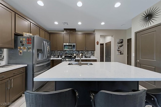 kitchen featuring a center island with sink, appliances with stainless steel finishes, and a sink