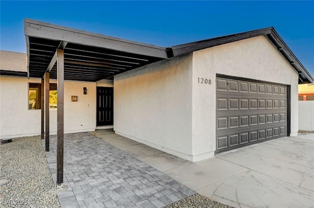 exterior space with a garage and a carport