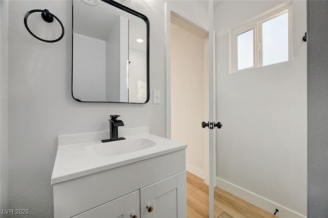 bathroom with wood-type flooring and vanity