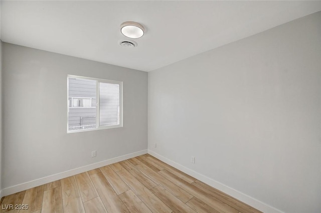 spare room with light wood-type flooring