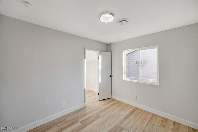 unfurnished room with light hardwood / wood-style floors