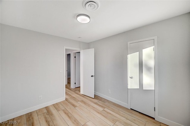 unfurnished bedroom featuring light wood-type flooring