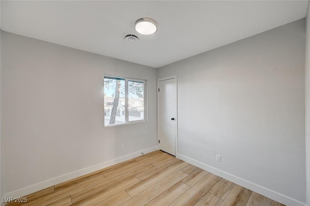 spare room featuring light wood-type flooring