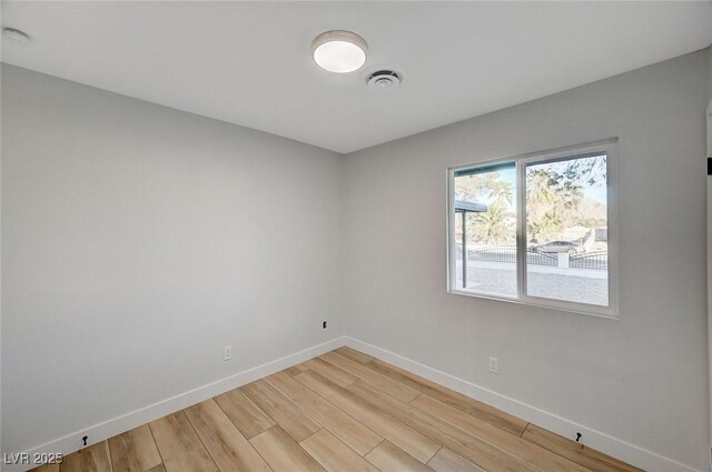 unfurnished room featuring hardwood / wood-style flooring