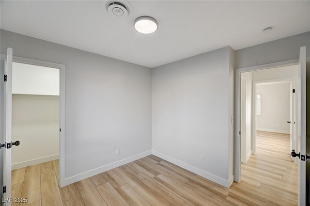 unfurnished room featuring light hardwood / wood-style flooring