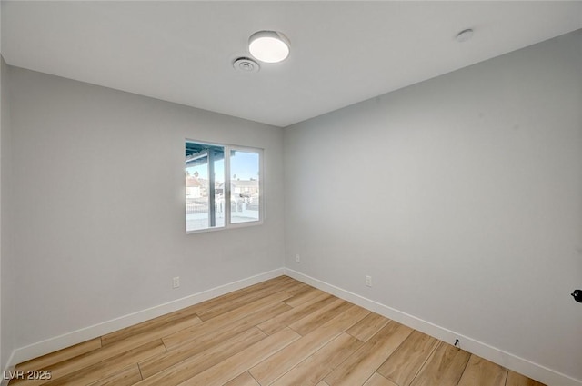 spare room with hardwood / wood-style floors