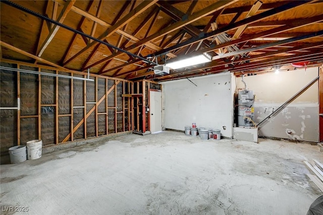 garage with a garage door opener and strapped water heater