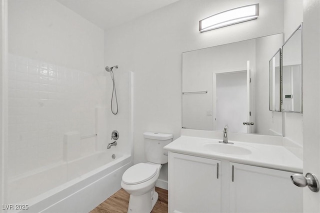 full bathroom featuring toilet, vanity, hardwood / wood-style flooring, and shower / bathtub combination