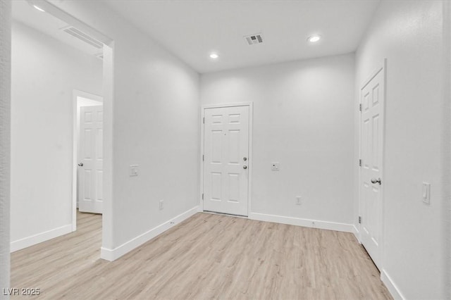 empty room with light hardwood / wood-style flooring