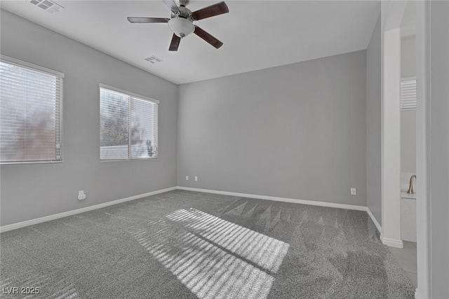 carpeted empty room featuring ceiling fan