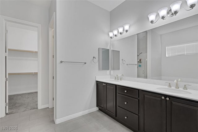 bathroom with tile patterned flooring, an enclosed shower, and vanity