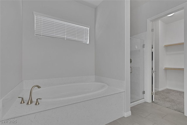 bathroom featuring separate shower and tub and tile patterned flooring