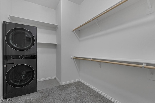 laundry room with stacked washing maching and dryer and light carpet