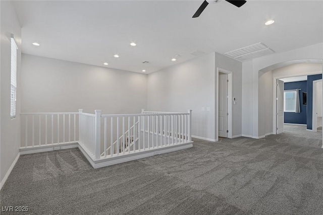 carpeted spare room featuring ceiling fan