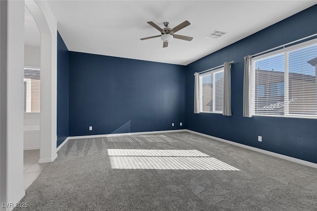 spare room featuring ceiling fan and light colored carpet