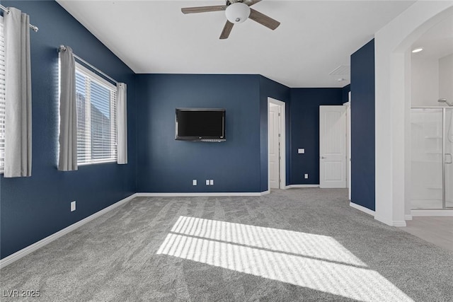 interior space featuring carpet, ceiling fan, and ensuite bathroom