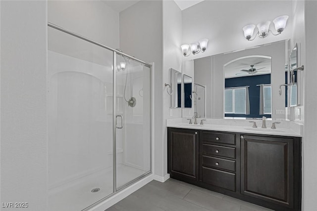 bathroom featuring ceiling fan, vanity, tile patterned floors, and a shower with door