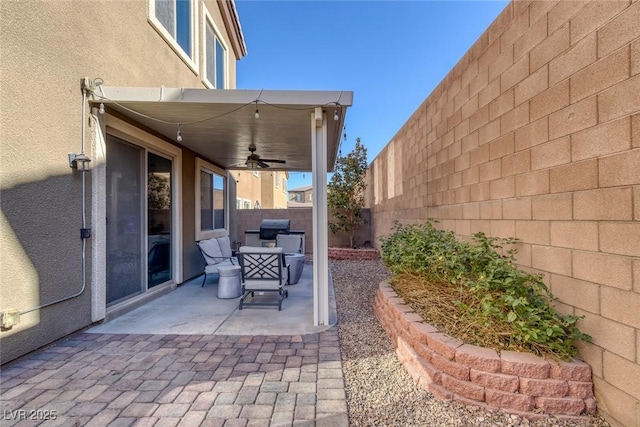 view of patio / terrace with ceiling fan and a grill