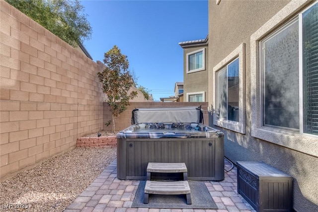 view of patio / terrace with a hot tub