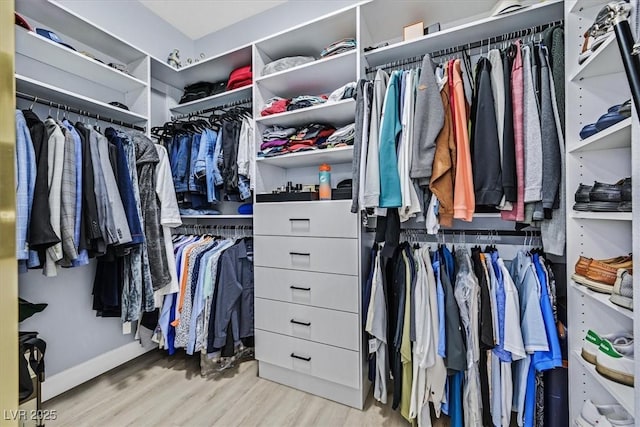 spacious closet featuring light hardwood / wood-style floors