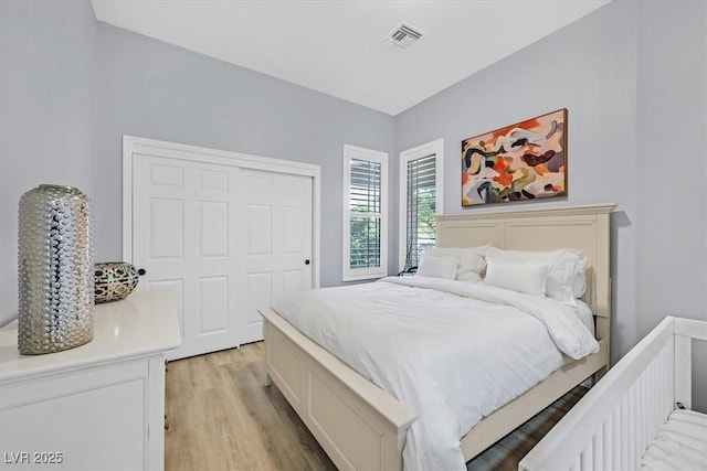 bedroom with a closet and light hardwood / wood-style floors