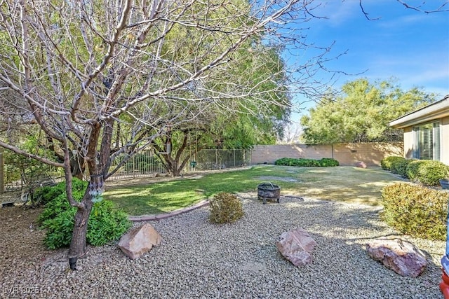 view of yard featuring an outdoor fire pit