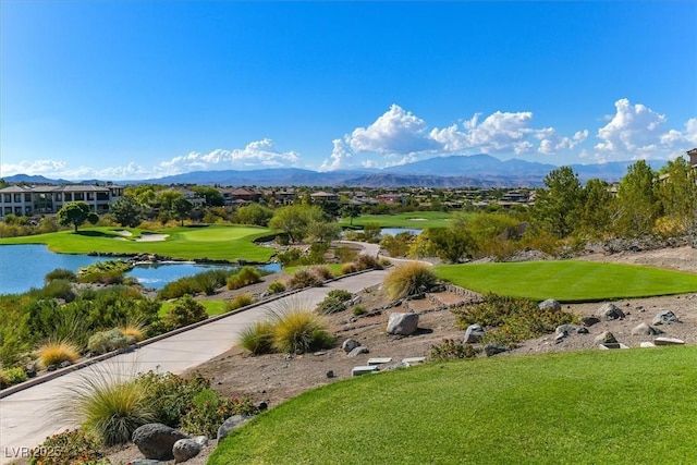 view of community with a water and mountain view and a yard