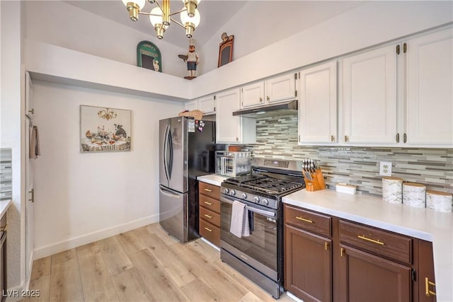 kitchen featuring white cabinetry, light hardwood / wood-style floors, backsplash, a chandelier, and appliances with stainless steel finishes