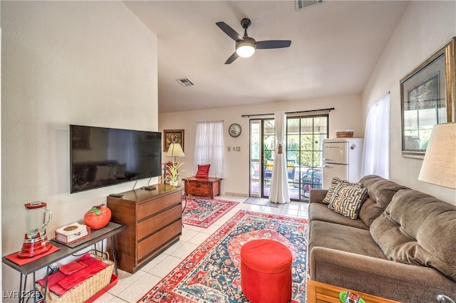 tiled living room with vaulted ceiling and ceiling fan