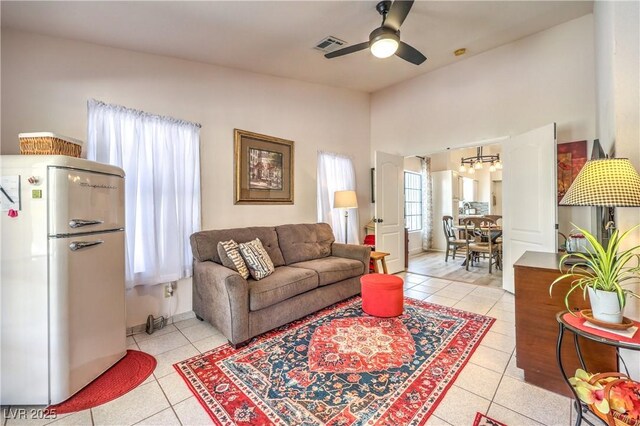 tiled living room featuring vaulted ceiling and ceiling fan