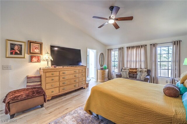 bedroom with light wood-type flooring, ceiling fan, and vaulted ceiling