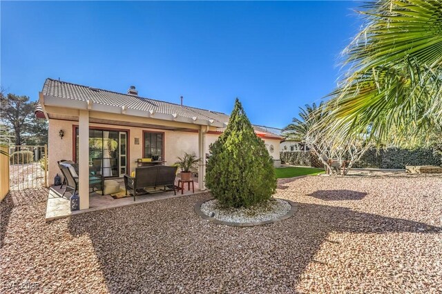 back of house with a patio