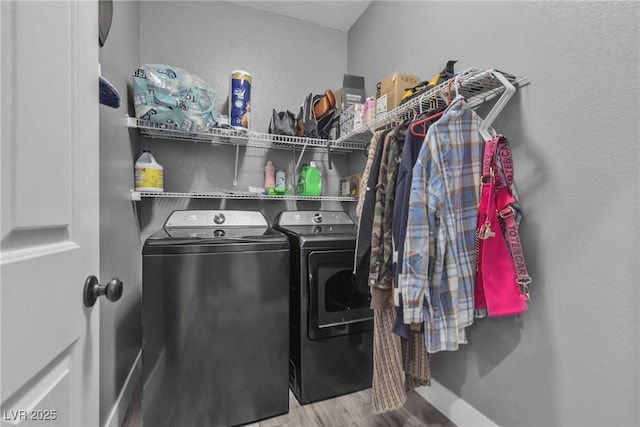 laundry area with washing machine and dryer and hardwood / wood-style floors