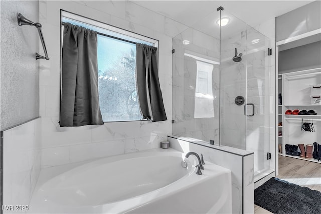 bathroom featuring a healthy amount of sunlight and separate shower and tub