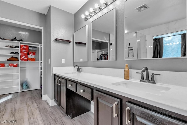 bathroom with vanity, hardwood / wood-style floors, and walk in shower