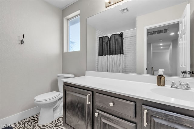 bathroom with toilet, tile patterned flooring, curtained shower, and vanity