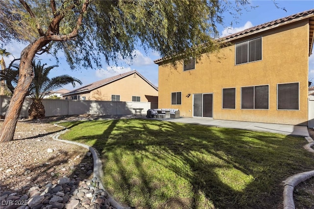 back of property featuring a lawn and a patio area