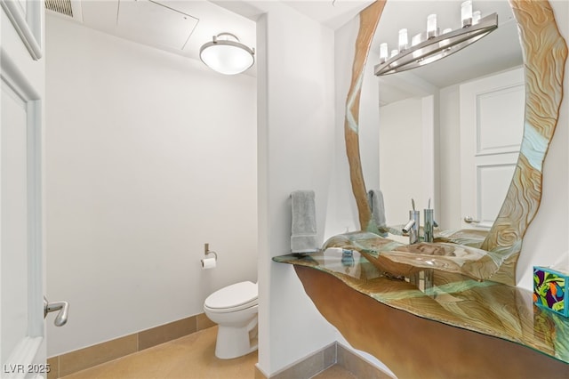 bathroom with tile patterned floors and toilet