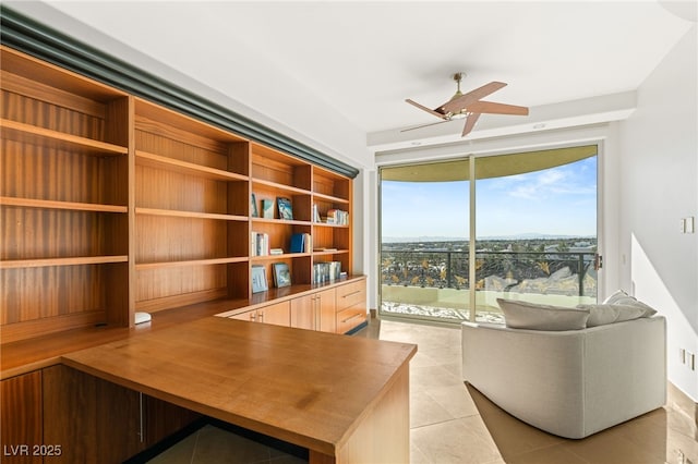 unfurnished office featuring ceiling fan and light tile patterned floors