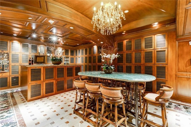 dining area with a notable chandelier and vaulted ceiling