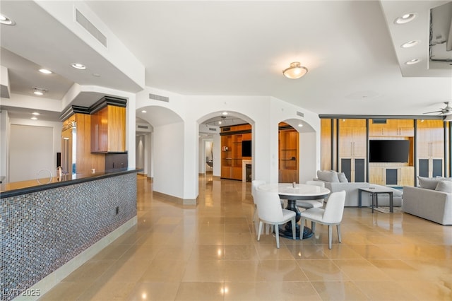 dining space with ceiling fan and light tile patterned floors