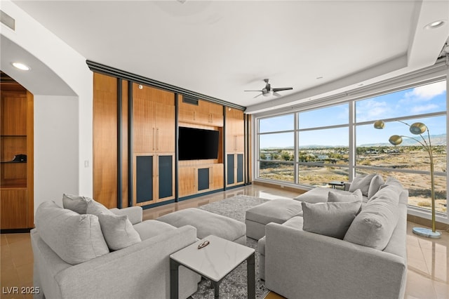 living room with ceiling fan, light tile patterned floors, and floor to ceiling windows