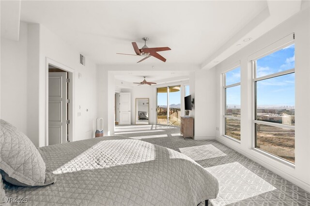 bedroom featuring ceiling fan and multiple windows