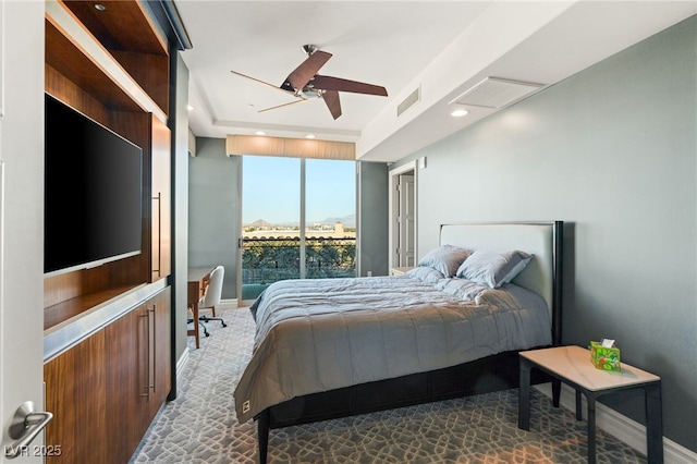 bedroom with ceiling fan and expansive windows