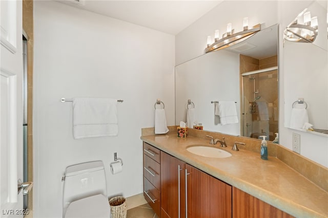 bathroom featuring walk in shower, vanity, tile patterned floors, and toilet