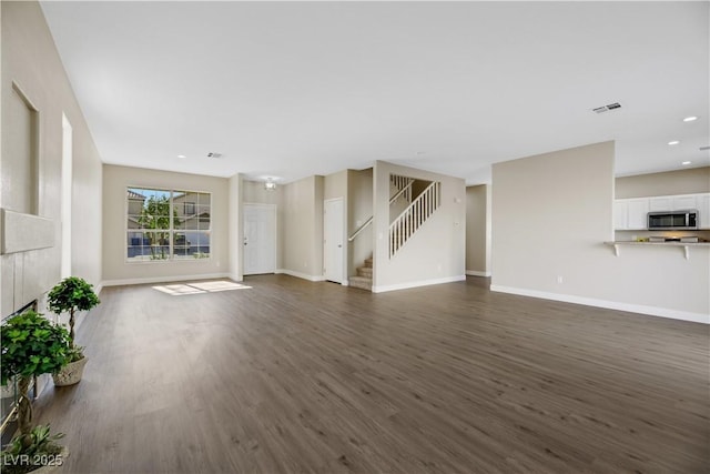 unfurnished living room with dark hardwood / wood-style flooring