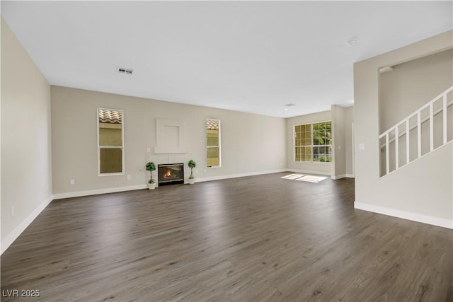 unfurnished living room with dark wood-type flooring