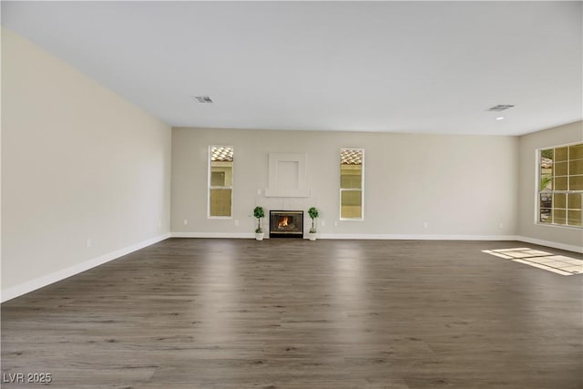 unfurnished living room with dark hardwood / wood-style floors