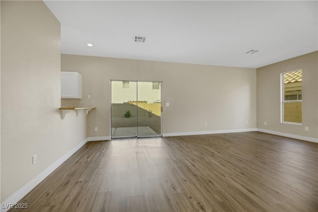 unfurnished living room with wood-type flooring